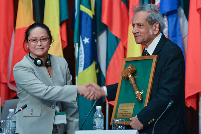 The incoming Chairperson, Jennifer Conje, presents a framed gavel to the outgoing Chairperson, Bin Che Yeom Freezailah, during the last day of ITTC-51
