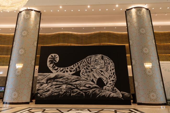 A painting of a snow leopard, done by Uzbeki artist Inkuzart, welcome delegates to the venue
