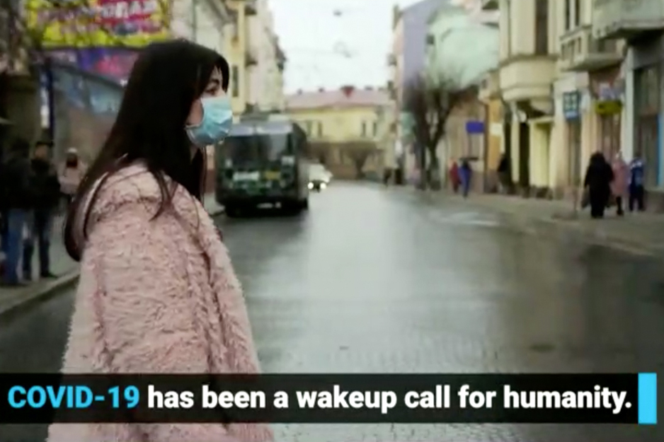 A slide from a video highlights that COVID-19 has been a 'wakeup call for humanity'.