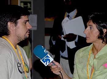 A Spanish television reporter interviews an NGO delegate.