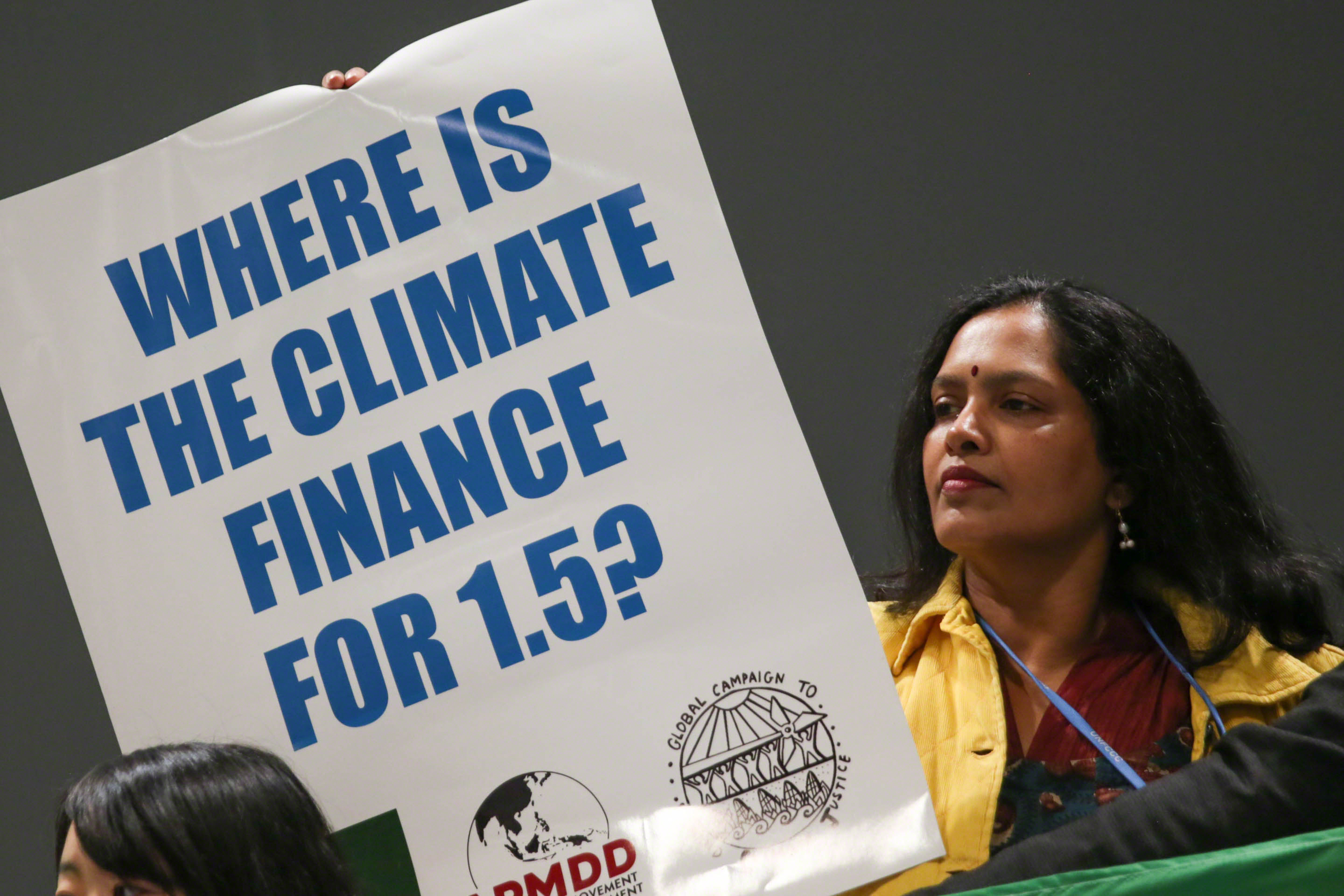 As discussions on finance began, members of civil society demonstrate in the corridors, calling for stronger financial mechanisms to effectively combat the climate crisis. 