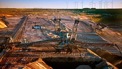 Brown coal surface mining with stacker, wind turbines in background