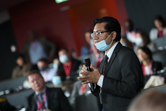 Participants ask questions during plenary