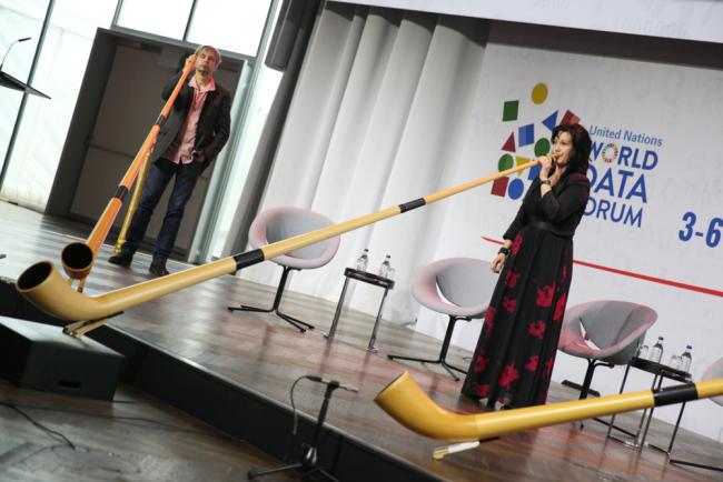 Musicians play the alphorn to welcome participants