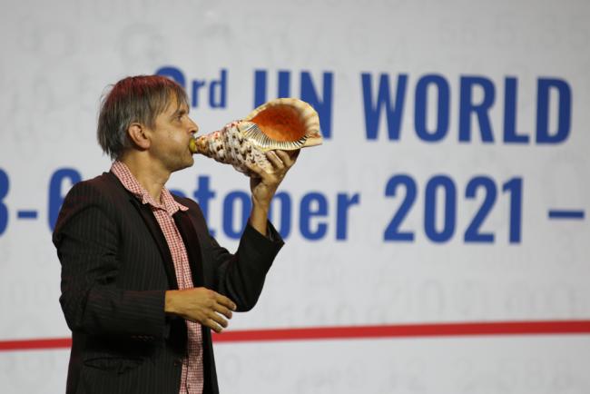 Musicians play the conch shell during the opening ceremony