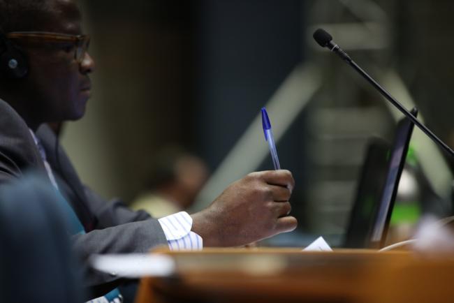 A delegate takes notes during the session