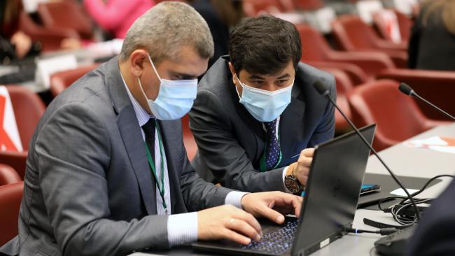 Delegates from Tajikistan conferring during a break in negotiations