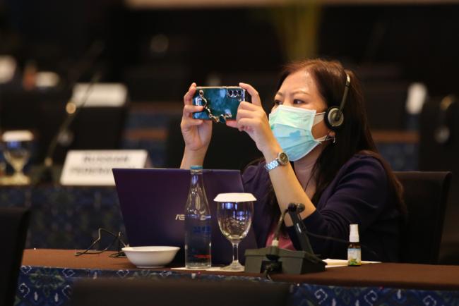 Delegate takes a photo of the contact group schedule