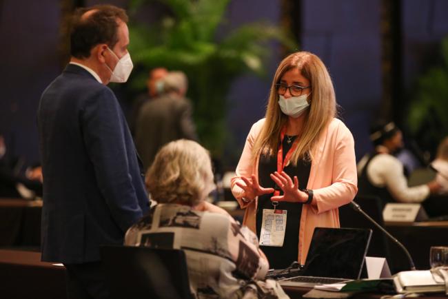 Delegates speak informally between sessions