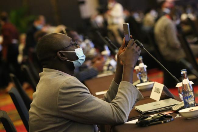 A delegate photographs the names of the newly elected bureau