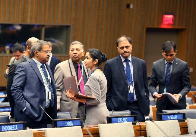 Delegates from India consulting before the start of the informal session