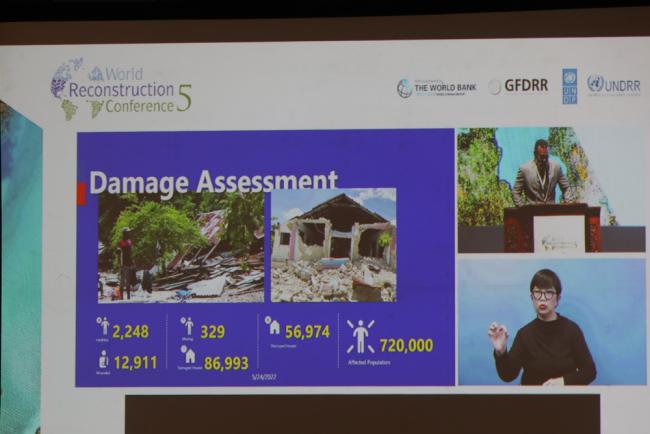 A slide demonstrates the extent of damage in Haiti due to disasters