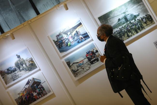 A delegate visits the photography exhibition on display