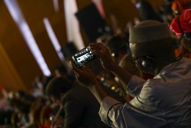 A delegate takes photos during a session