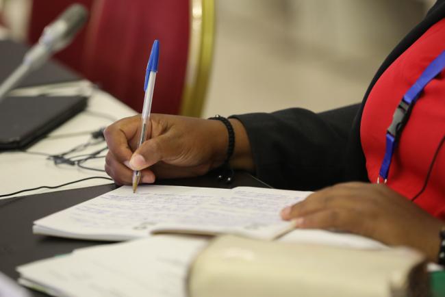 A delegate takes notes during the COW