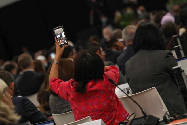A delegate takes a photo during the session