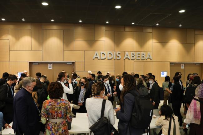 Delegates gather outside the meeting room for the first dialogue of the Global Stocktake