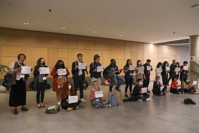 In a second demonstration, members of civil society sing in corridors, calling for more finance for ACE initiatives and reminding delegates that they have the power to make a change in the world