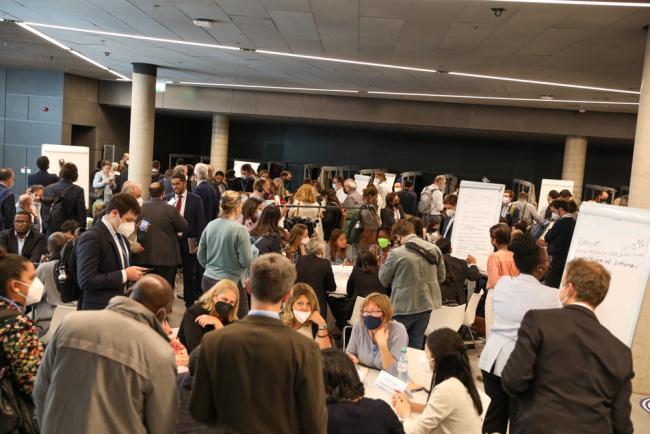 A World Cafe is held in an effort to make the GST discussions engaging and informal, with delegates moving between 12 thematic tables to exchange views and ideas