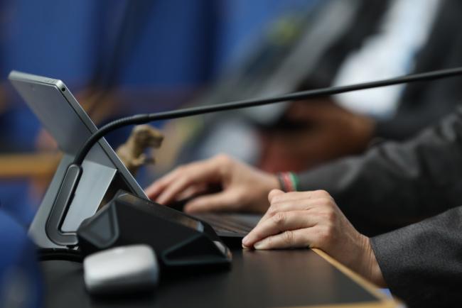 A delegate takes notes during the session