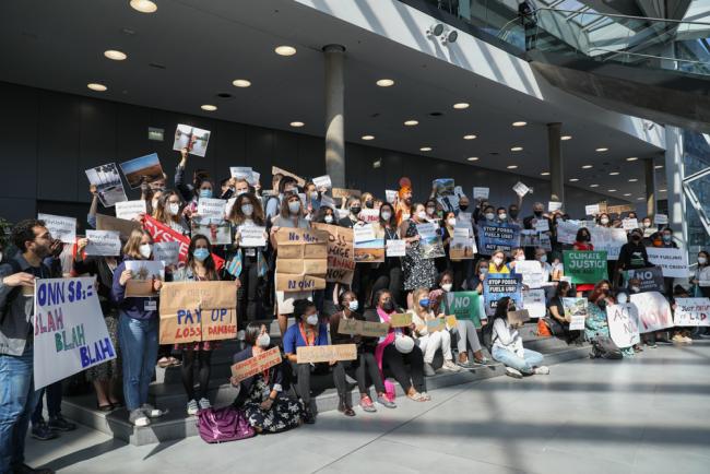 On the final day of negotiations, members of civil society demonstrate outside the closed negotiating rooms, calling for more action to be taken to address climate change