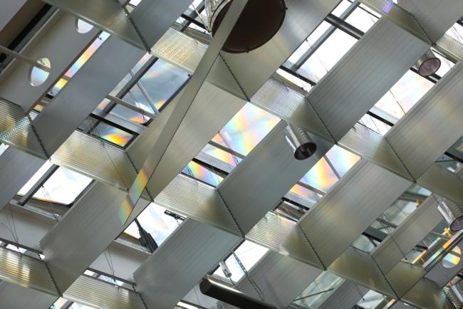 Rainbows stream through the ceiling as the plenary takes place