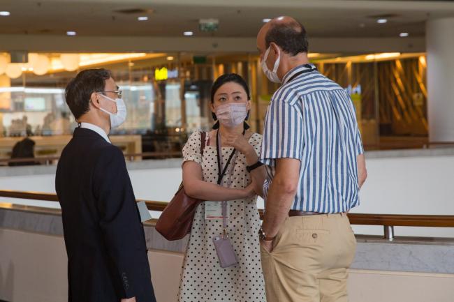 Delegates confer during lunch - OEWG-44-ExMOP-5 - 11Jul2022 - Photo.jpg