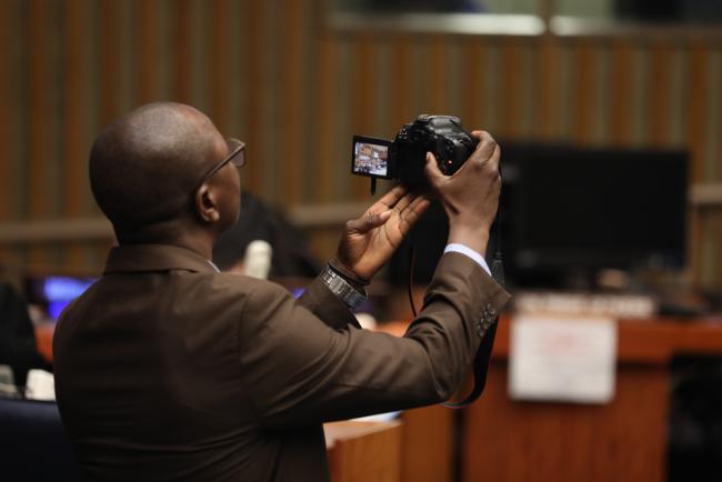 Delegates take photos of the speakers