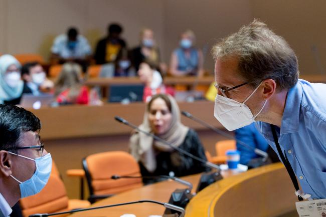 Masked delegates chatting - OEWG-44/ExMOP-5 - 15Jul2022 - Photo