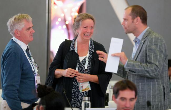 Delegates conferring during a break in negotiations