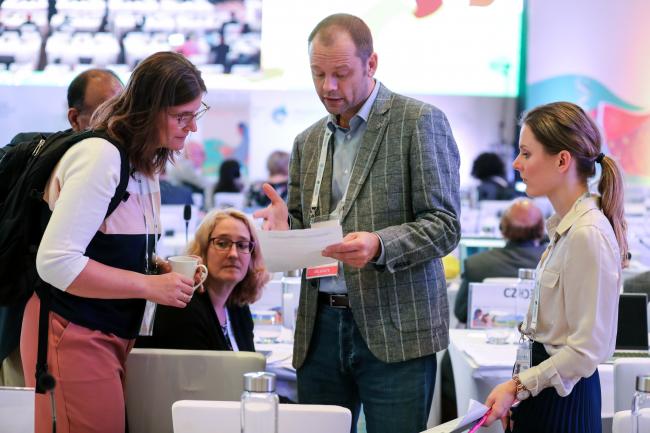 Delegates conferring during a break in negotiations