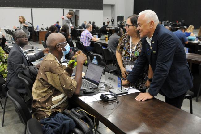 Delegates from Guyana and Costa Rica confer before the morning session