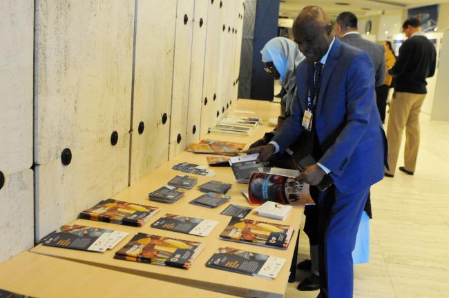 Participants check the IGF materials distributed at the venue