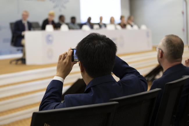 Observers recording the side event