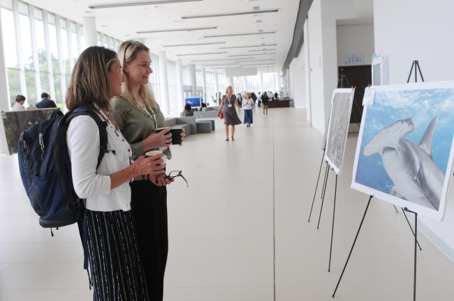 Participants admire the art displayed at the venue