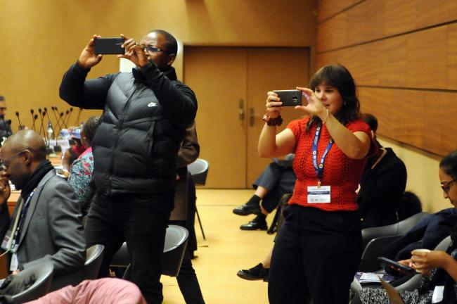 Participants take photos of the panels