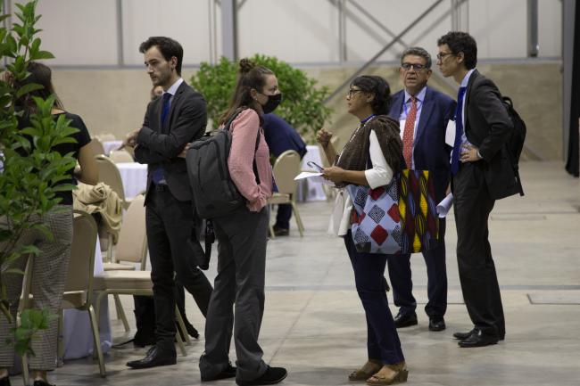 Delegates huddle during the informal consultations