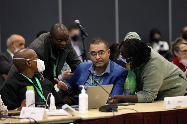 Delegates conferring during a contact group on GBF targets