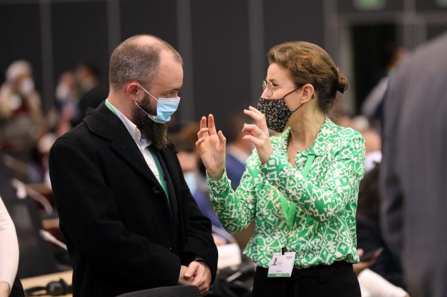 Delegates from Belgium conferring before the start of the plenary