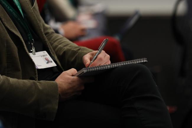 A delegate takes notes