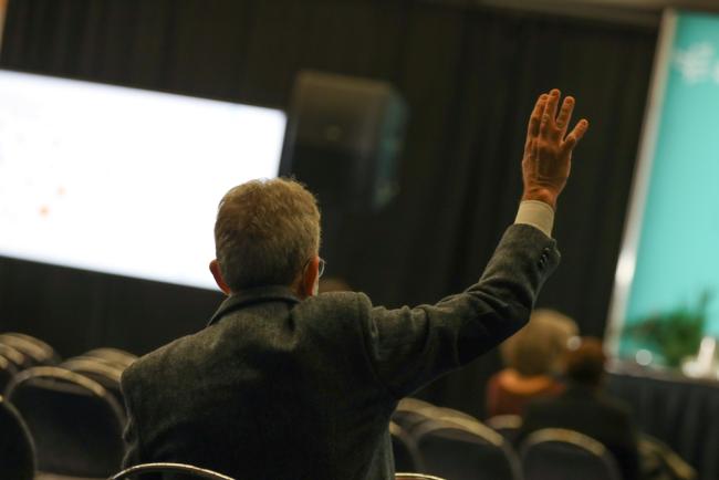 Delegates ask questions from the floor