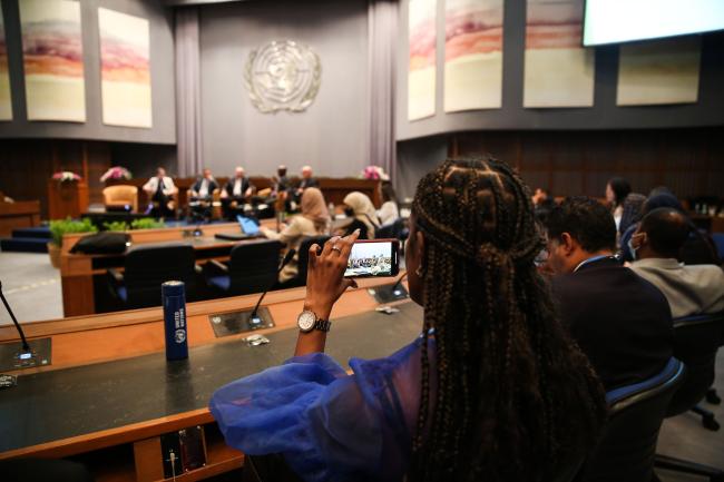 A delegate takes a video of the speakers_OEWG1.2_30jan2023_photo.jpg