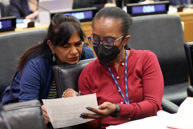 Participants conferring during a break in negotiations