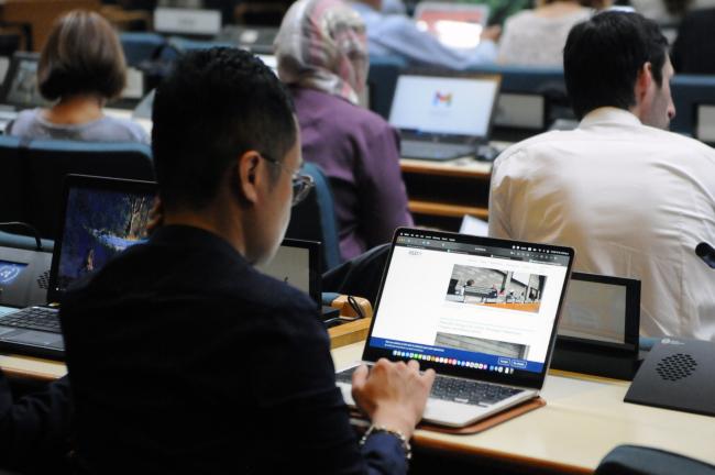 A participant checks the Earth Negotiations Bulletin (ENB) website