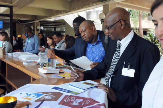 Delegates check publications available at the venue