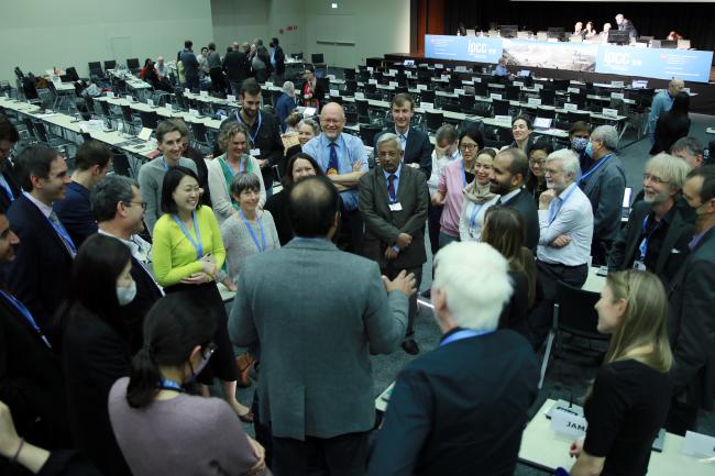 Delegates consulting in a huddle 