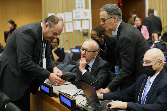 Delegates conferring during plenary