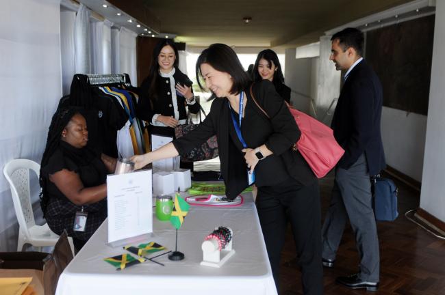 Delegates from Singapore appreciate the local souvenirs available at the venue
