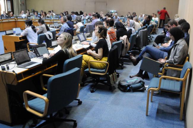 Delegates follow the negotiating text on screen