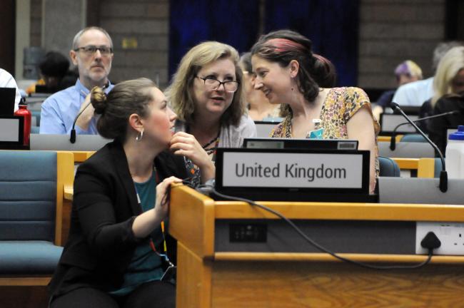 Delegates from the US, Canada, and the UK, confer during the Thematic Group